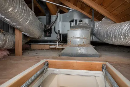 Aging attic ductwork in Gulf Breeze showing worn seals and light corrosion