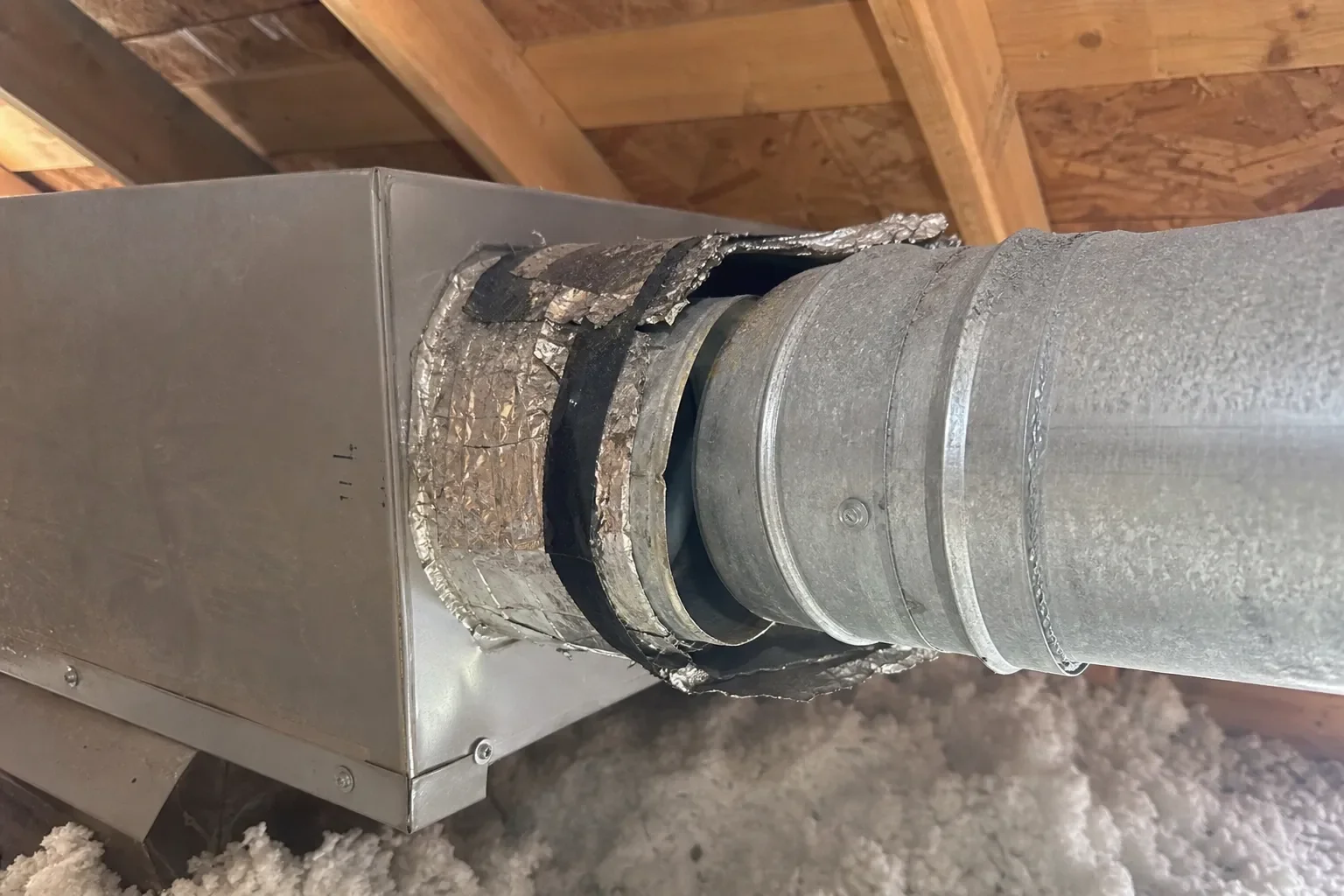 Damaged air duct connection in a Gulf Breeze property showing wear that may need repair